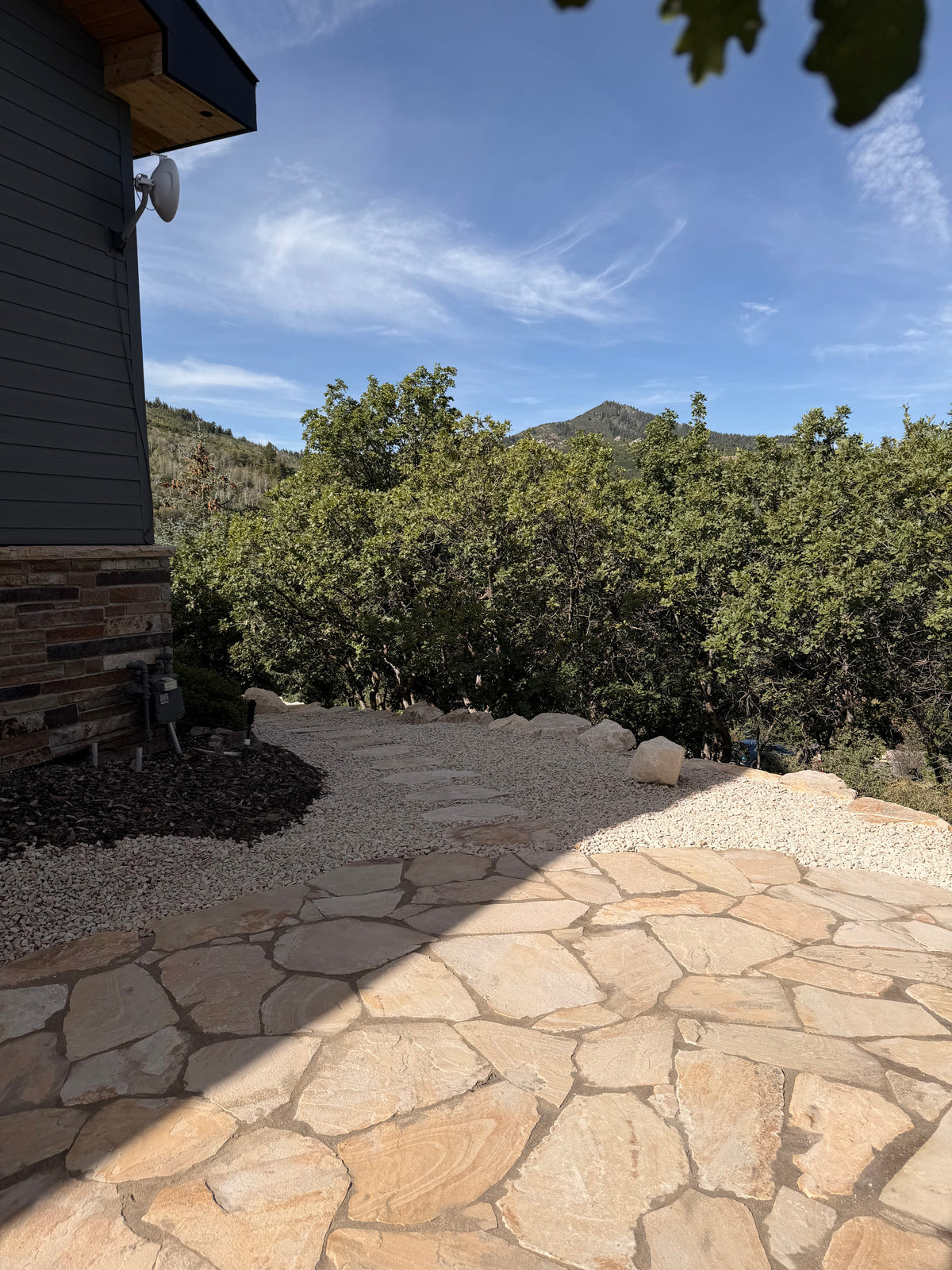 Flagstone patio with gravel path and mountain view at a Park City home