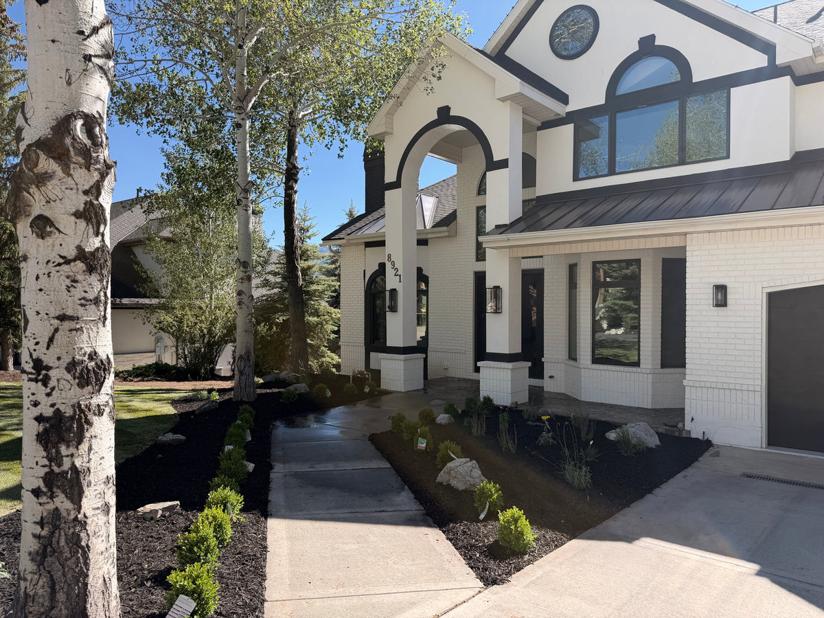Walkway and garden beds along a driveway in a Park City landscape project