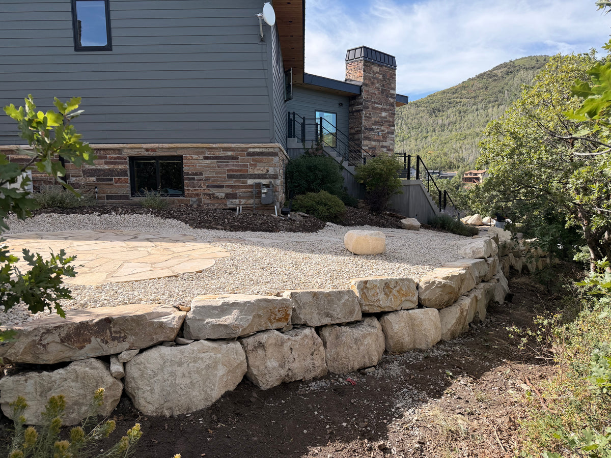 Natural boulder retaining wall in a Park City landscape renovation